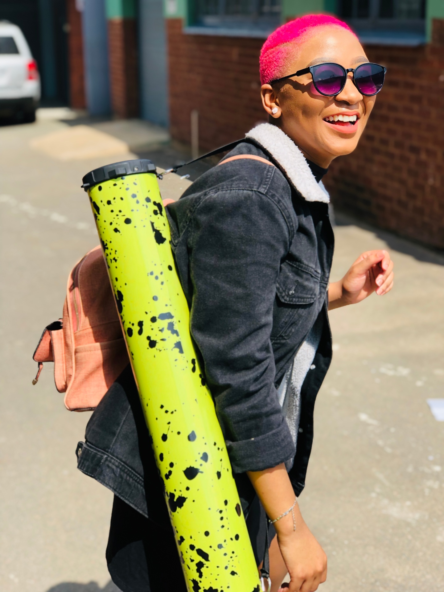 Turnup customer with pink hair carrying a neon yellow splatter speaker